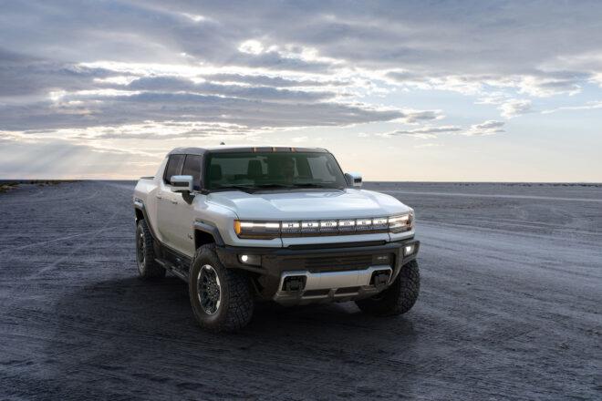 white electric Hummer in gray landscape