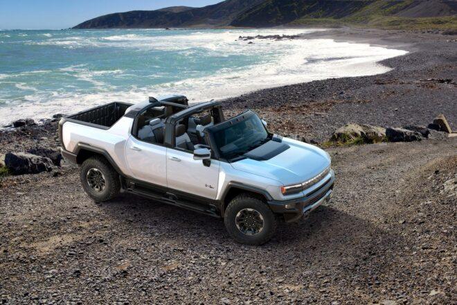 white electric Hummer parked by the beach