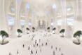 rendering of airport interior with curving white walls, skylights, and trees growing inside