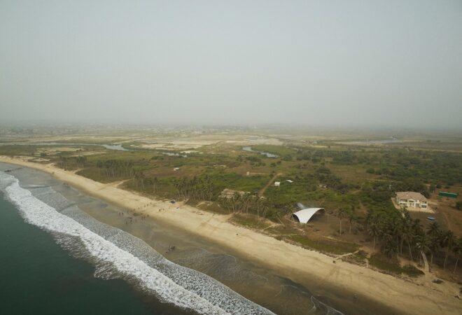 aerial view of large white arch near the ocean
