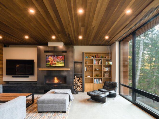 living area with gray sofa, fireplace and wood ceiling