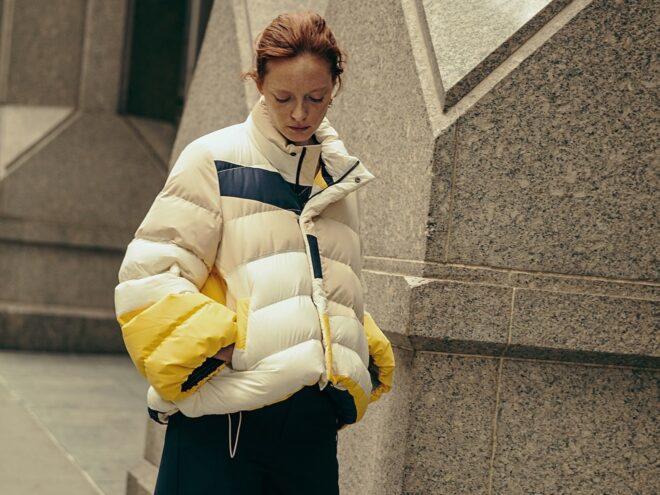 person wearing puffer jacket with multiple colors
