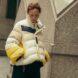 person wearing puffer jacket with multiple colors