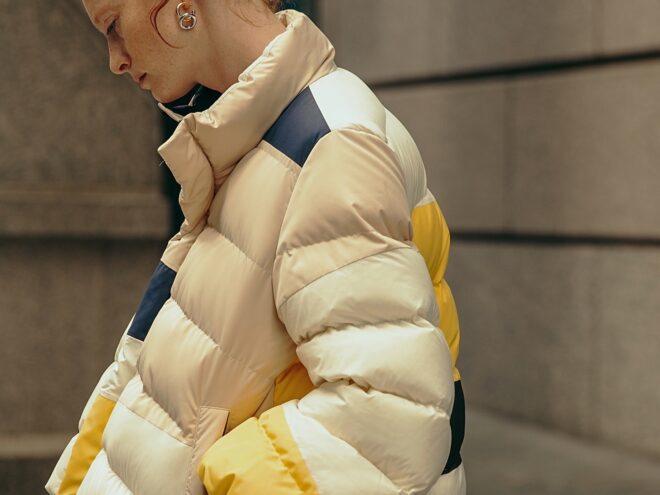 closeup of yellow, beige and navy puffer jacket