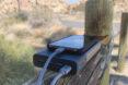 phone plugged into portable charger in the desert