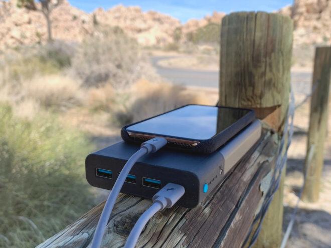 phone plugged into portable charger in the desert