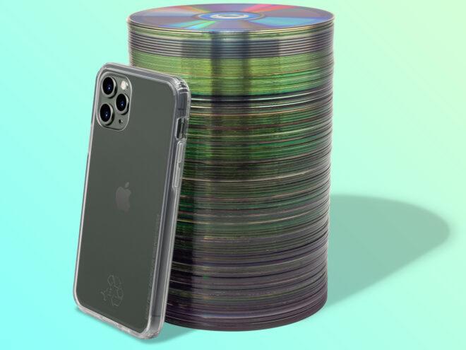 phone with clear case leaning against stack of CDs