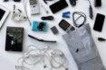 old tech gadgets spilling from recyclable bag
