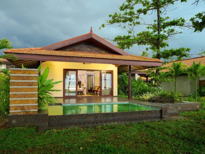 pool next to yellow villa