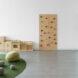 round seats, turf, inbuilt wood bookshelves and a small rock-climbing wall