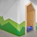 white room with green mountains painted on the wall