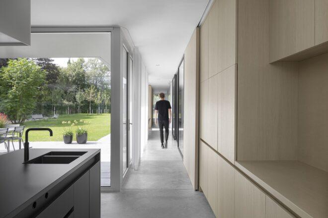A hallway off the kitchen, showing a person walking.
