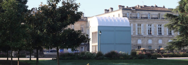 large white timber building with domed roof