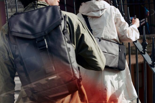 two people wearing bags made of recycled materials