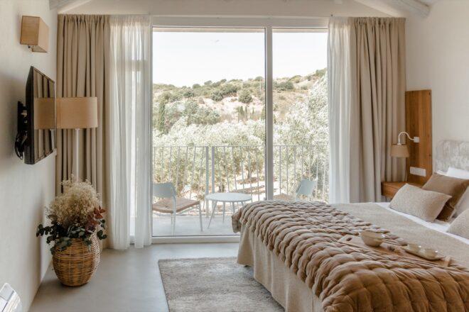 large white bed near wall of sliding glass