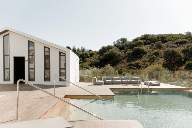 swimming pool next to white gabled building