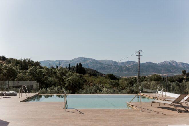 swimming pool in foreground and mountains in background