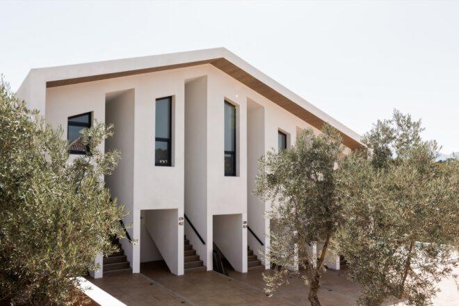 white gabled building with tall, narrow windows