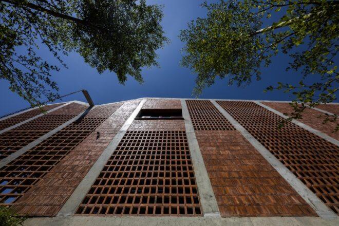 worm's eye view up toward tall brick building