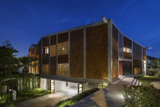 two-story brick home at night