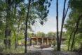 gray and light timber building surrounded by forest