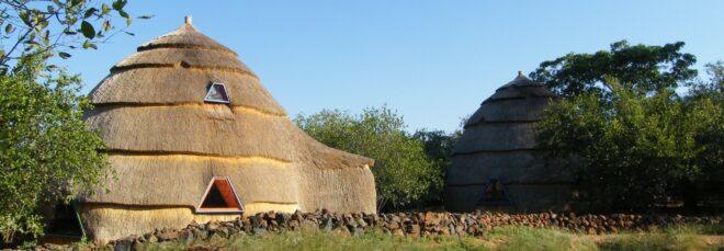 Two thatched domes with trapezoid-shaped windows.