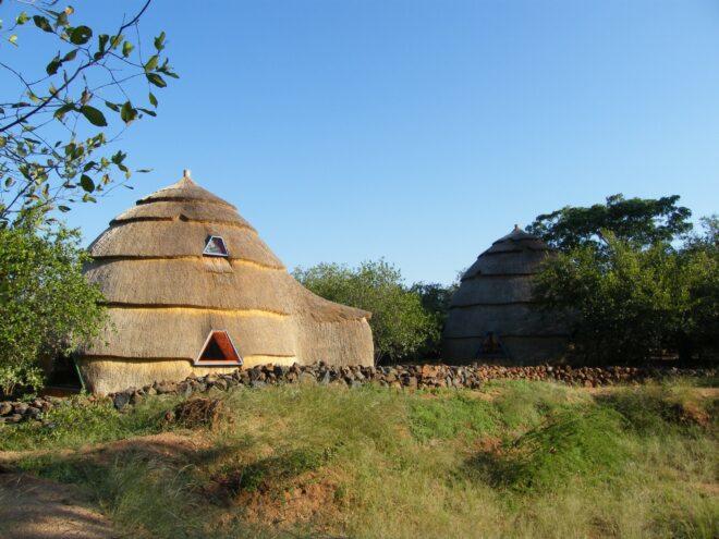 Two thatched domes with trapezoid-shaped windows.