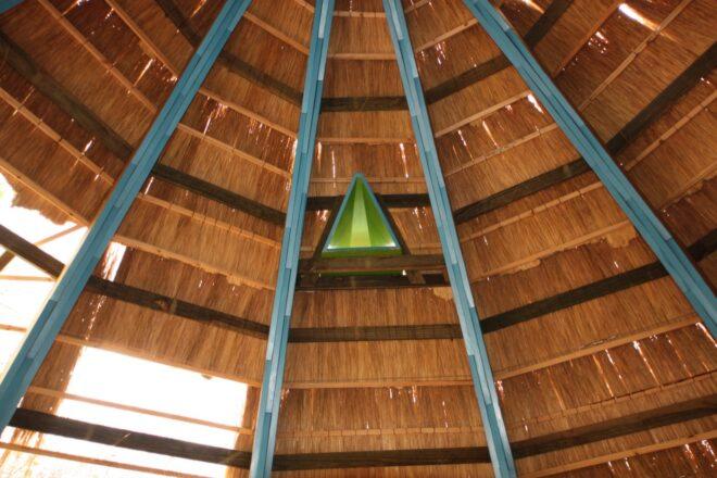 The interior roof of a thatched dome building.