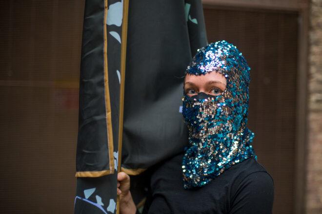 person wearing blue sequin mask