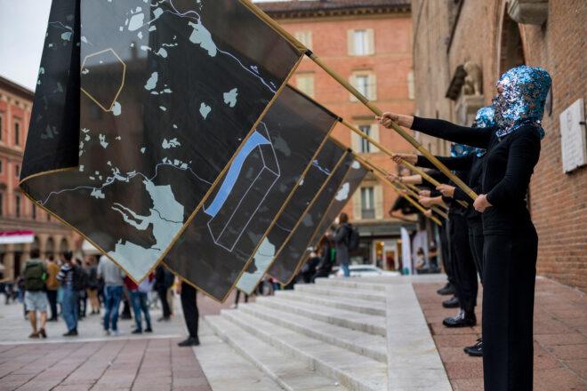 line of people holding flags with maps on them