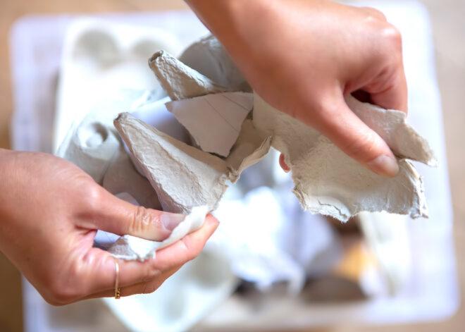 person tearing egg carton