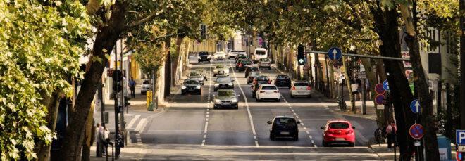 cars driving on 4-lane road in a city