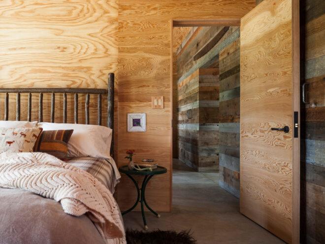 large bed in room with wood walls
