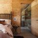 large bed in room with wood walls