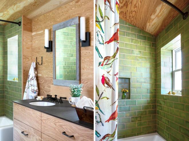 Bathroom with green shower tiles and wood cabinets