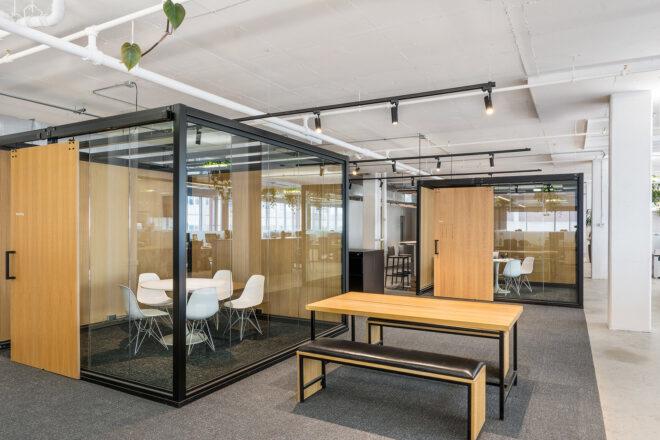 wood table near enclosed glass meeting room