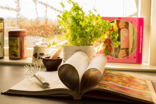 cookbook and whisk on kitchen counter