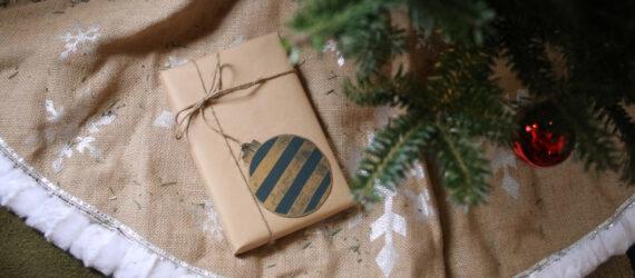 gift wrapped in brown paper placed under a Christmas tree