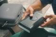 person removing powerbank from carrying case