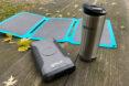 metal mug near solar panels and powerbank