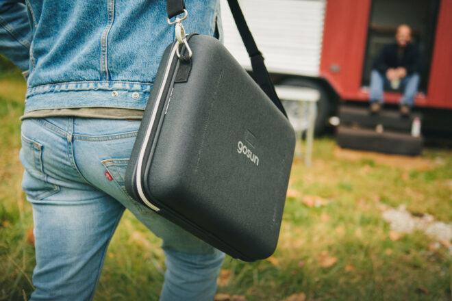 person walking with black carrying case