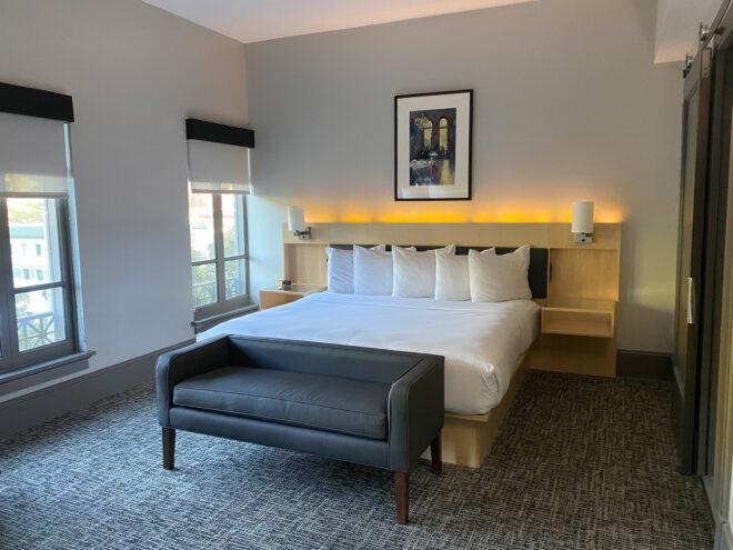 plush hotel bed in white hotel room