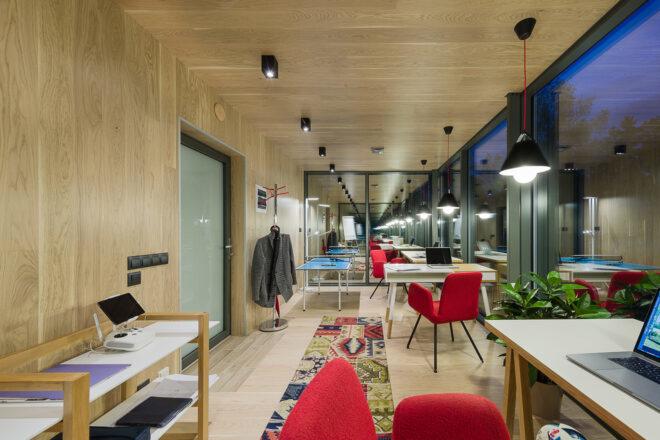 wood desks and red chairs in wood cabin