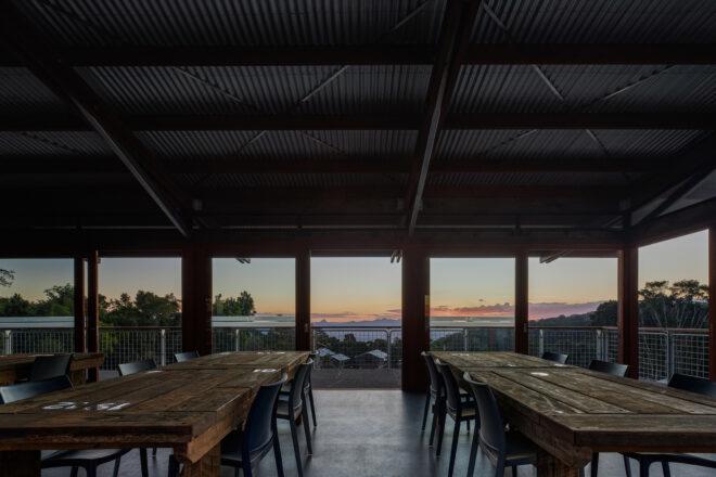long wood tables in room with glass walls