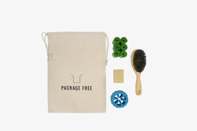 zero-waste kit with dog poop bags, brush, and chew toy