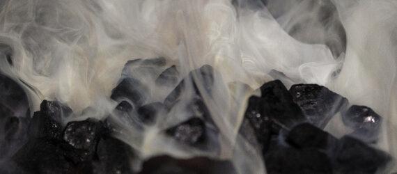 Smoke rising from a pile of burning coal.