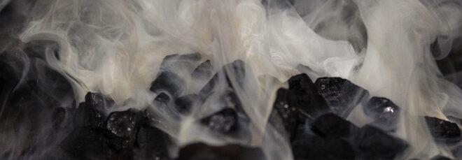 Smoke rising from a pile of burning coal.