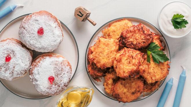 sufganiyot and latkes on marble background