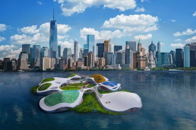 A cityscape with a green campus situated on the water.