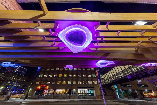 A close-up of a purple light on a wood canopy.